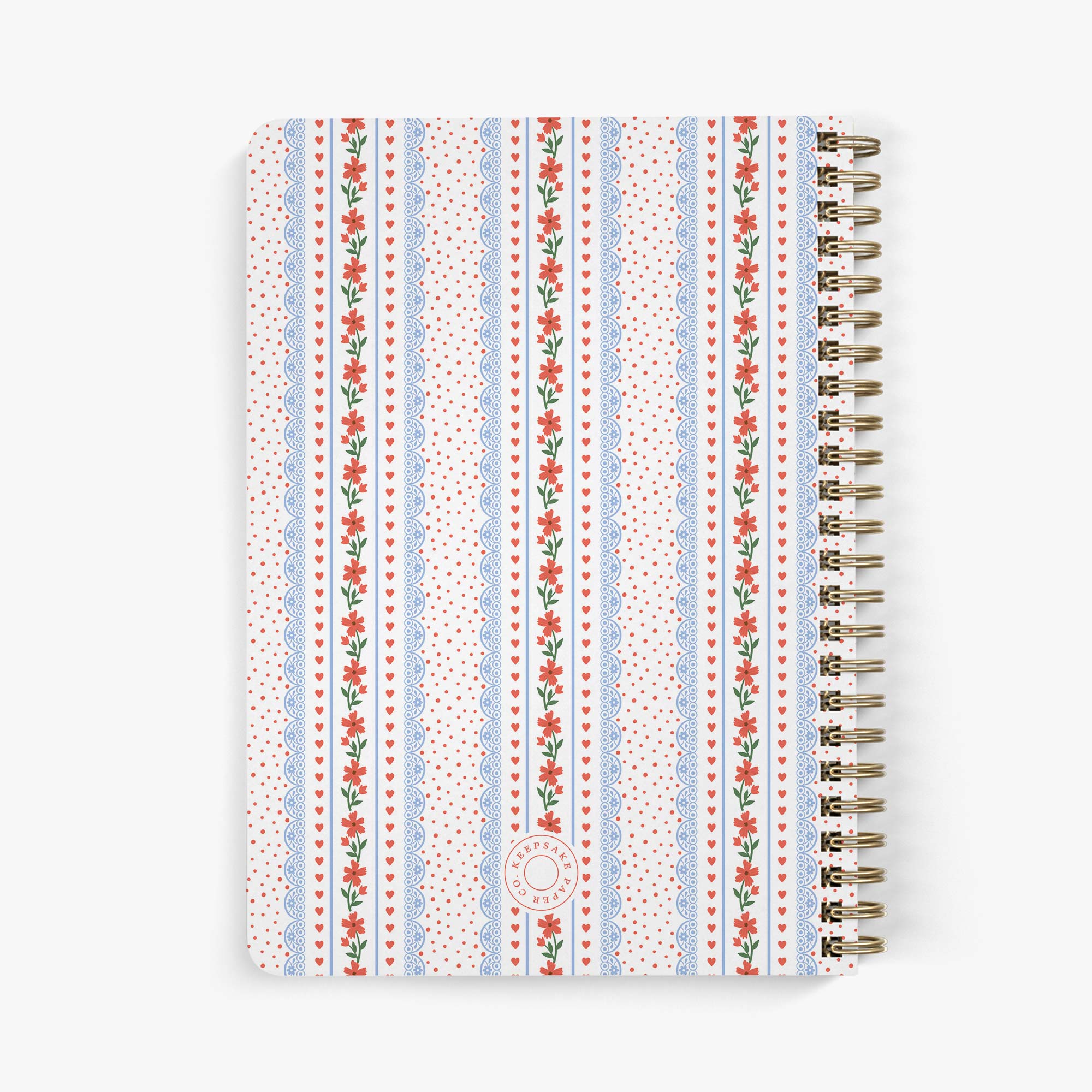 Back view of needlepoint journal with  hearts and floral patterned cover on a white background