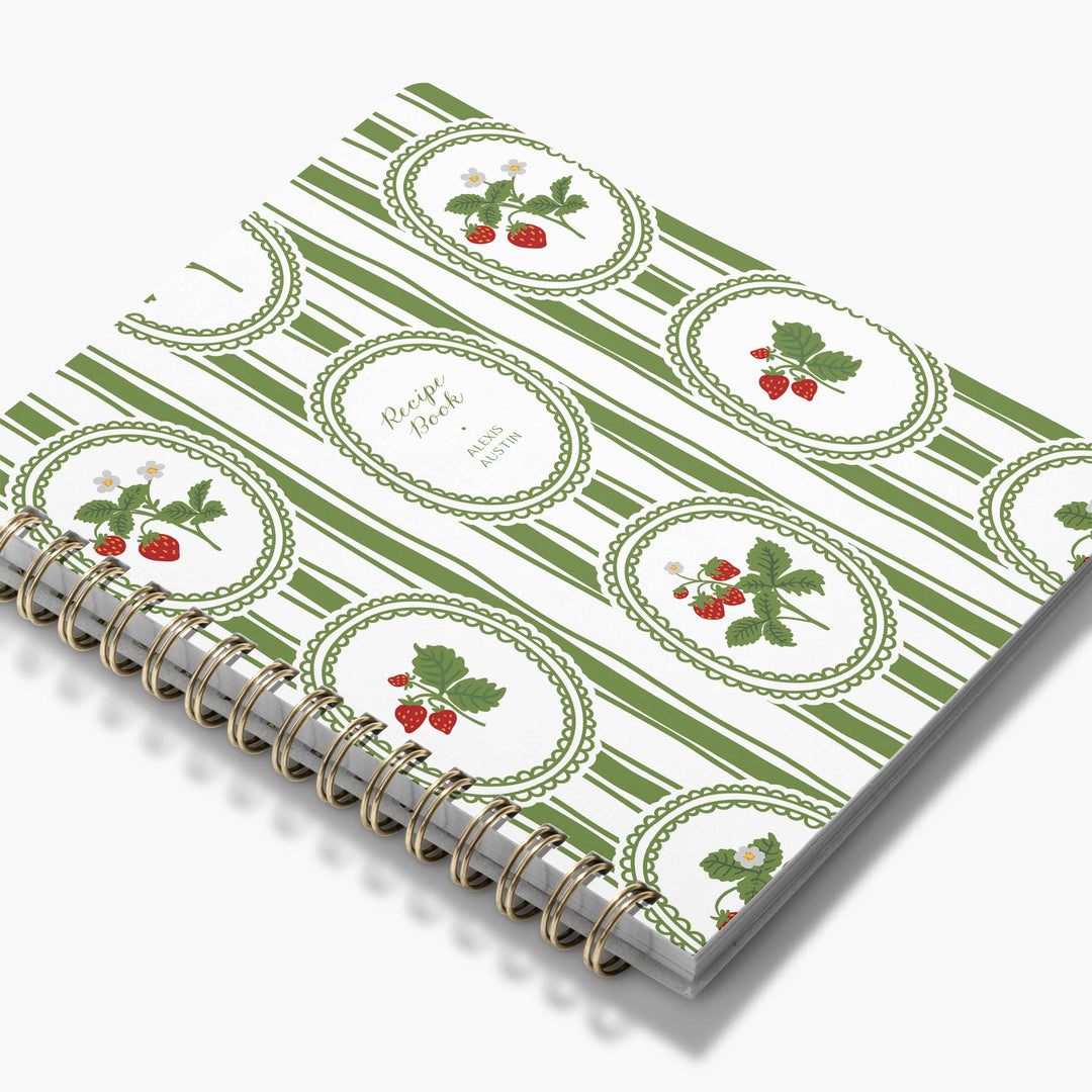 Personalized recipe notebook with green and white striped cover with berries and leaves.