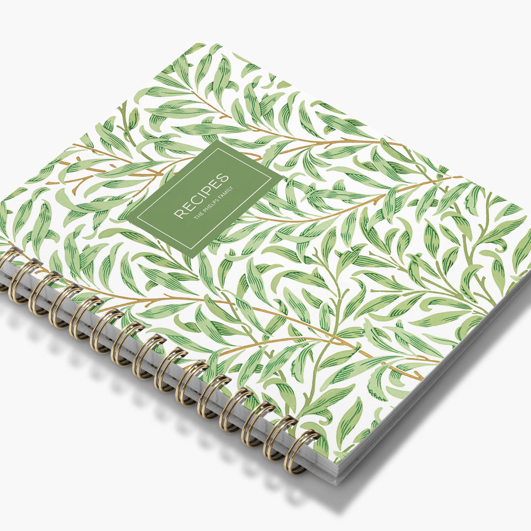 Personalized recipe notebook with art deco inspired green leaf pattern on a white background
