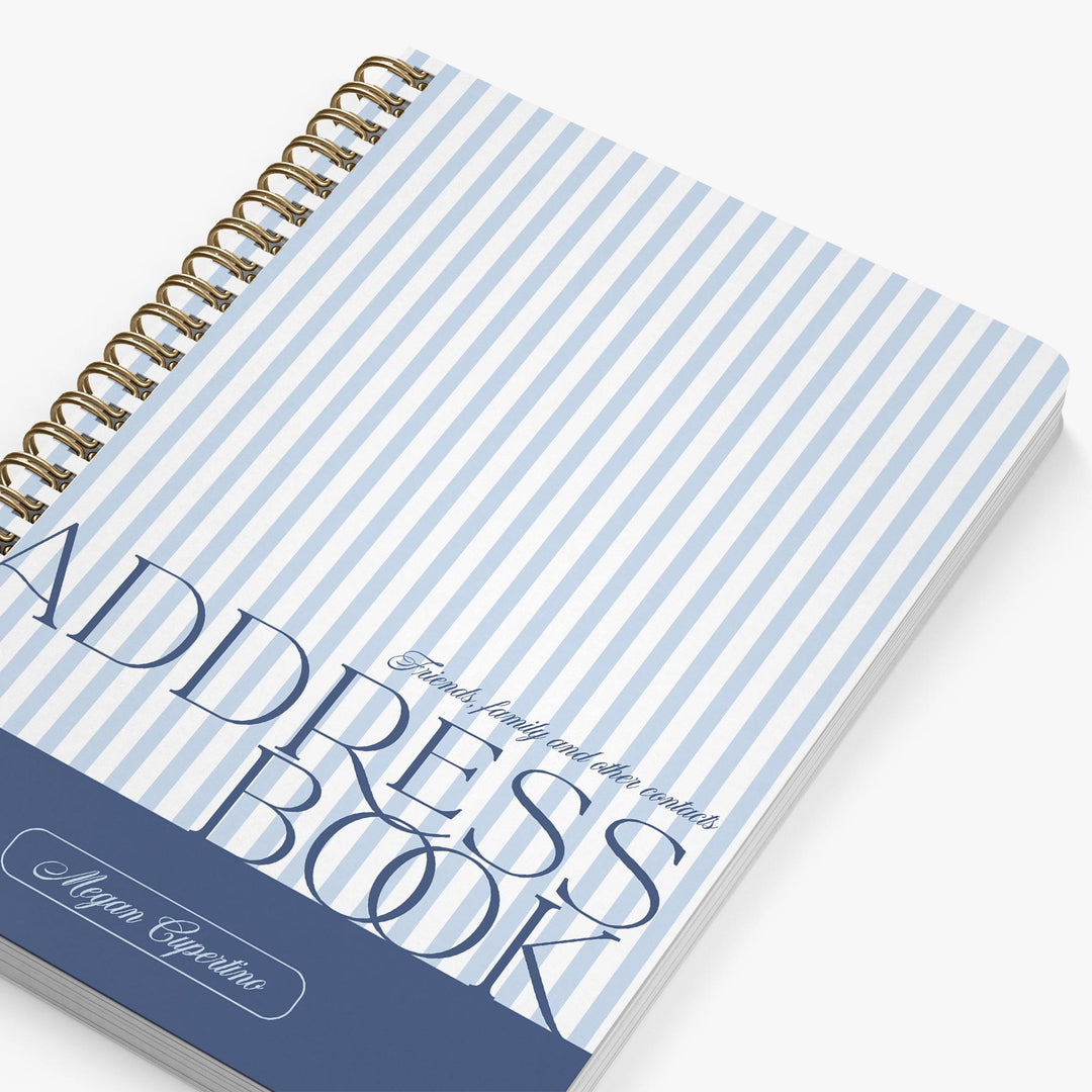 Address book with blue and white striped cover on a white background
