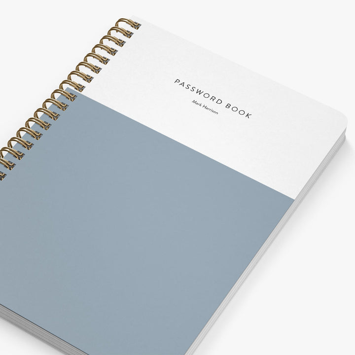 Password book with gold spiral binding on a white background