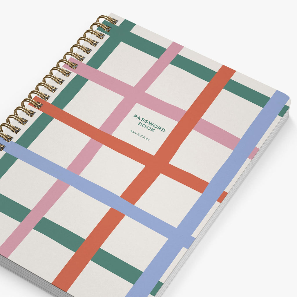 Close up of personalized password book with colorful grid design on a white background