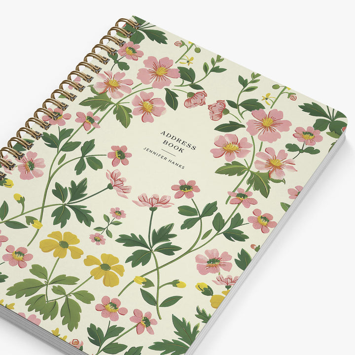 Floral patterned address book with pink and yellow flowers on a white background