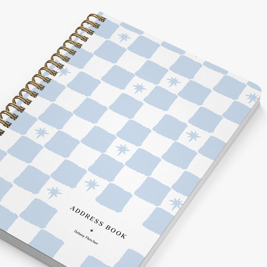 Address book with blue and white checkered pattern on a white background