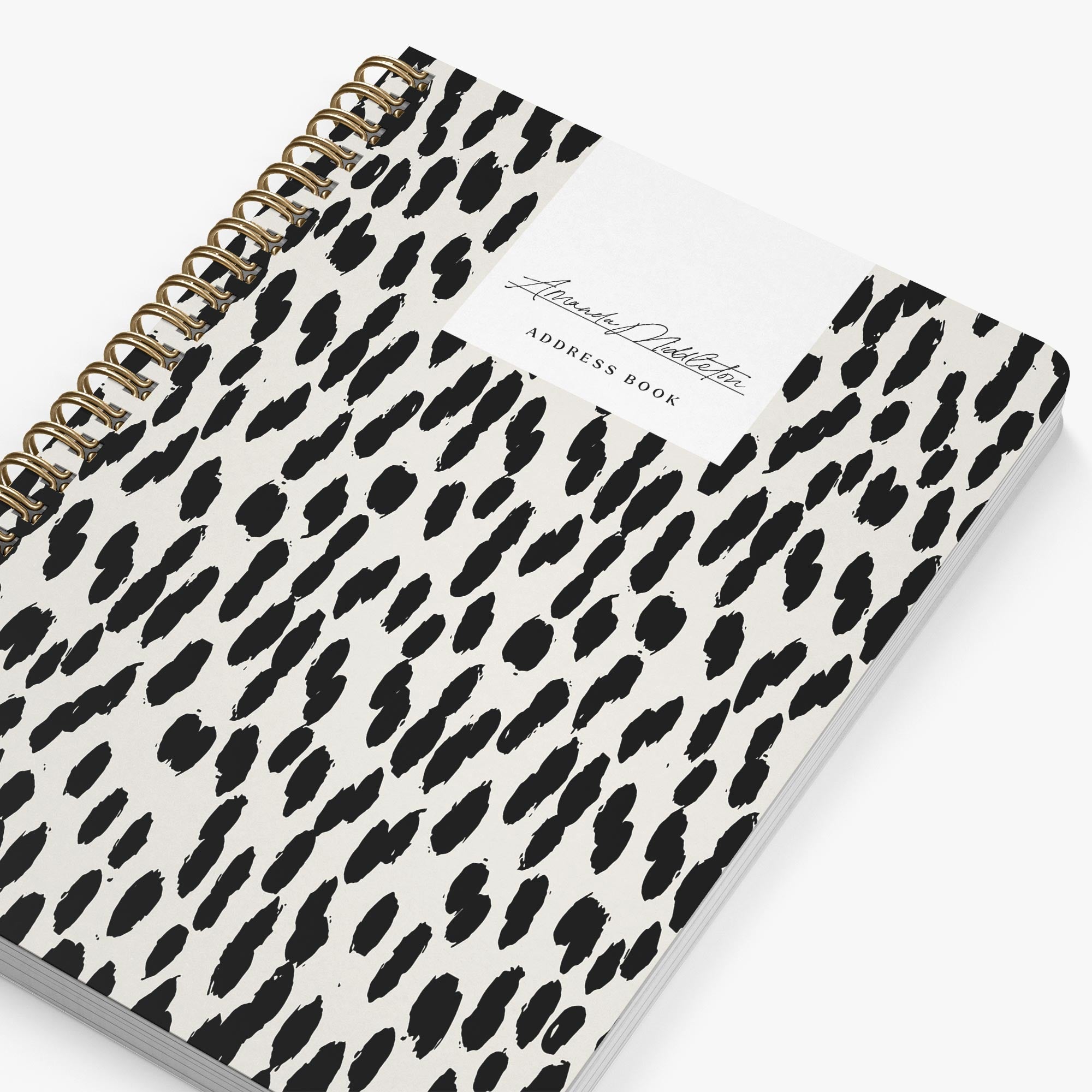 Address book with black and white leopard print cover on a white background