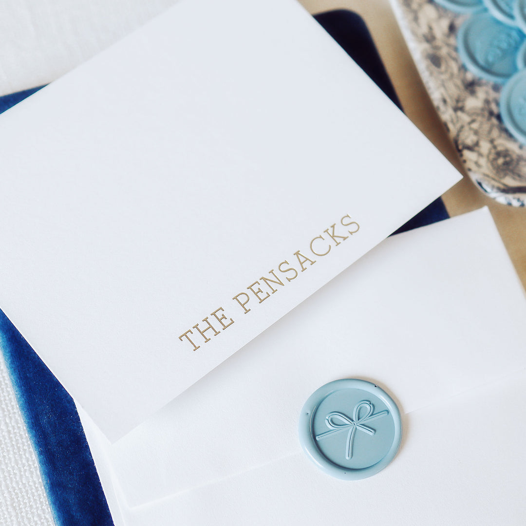 Foil pressed notecard with last name on white cotton paper with envelope and wax seal