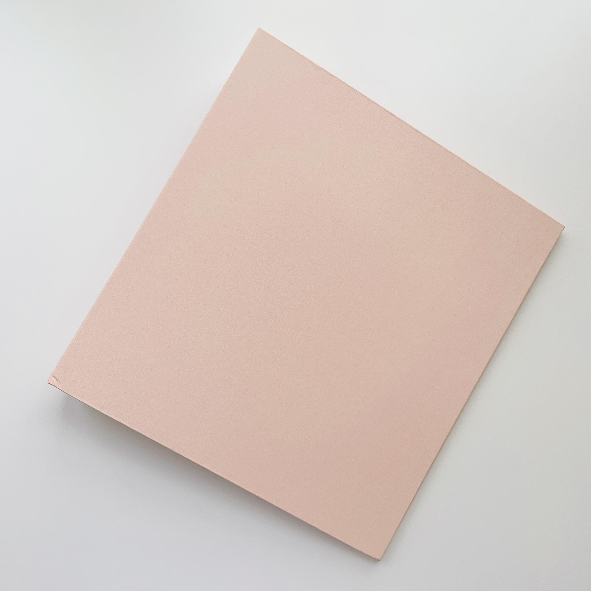 Pink linen binder on a light gray background