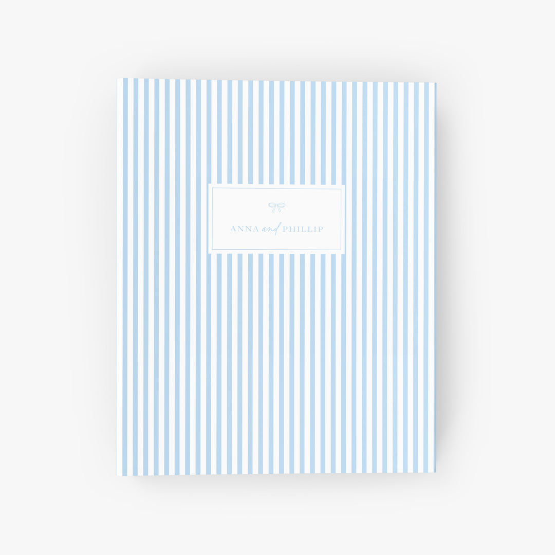 Personalized blue & white stripe wedding planning binder with the names of the bride and groom
