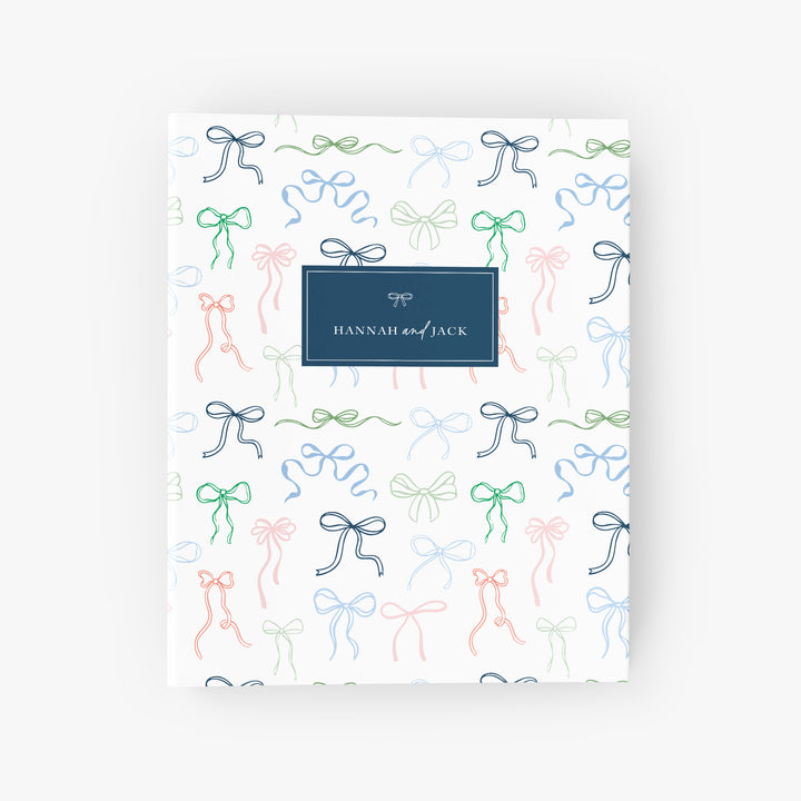 Custom wedding binder featuring a design of colorful ribbons tied into darling bows, personalized with the couple's name on the cover