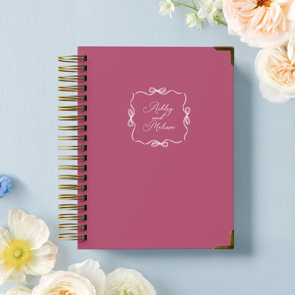Our LGBT wedding planner books are all-inclusive and gender-neutral, shown in an adorable coquette style ribbon bow frame