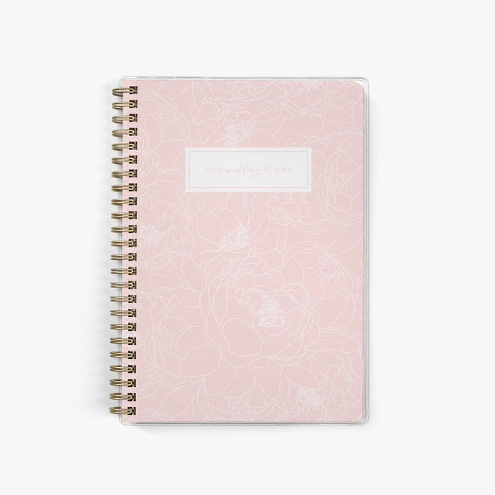 Soft pink elopement planner with delicate white peony floral cover, ideal for romantic wedding planning and bridal gifts