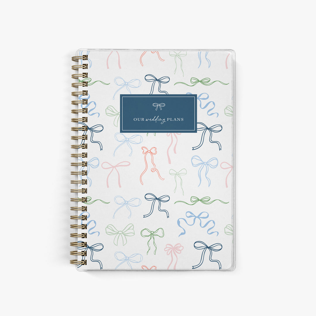 Whimsical wedding planner with multicolor hand-drawn bow cover design, perfect for fun, personalized bridal planning