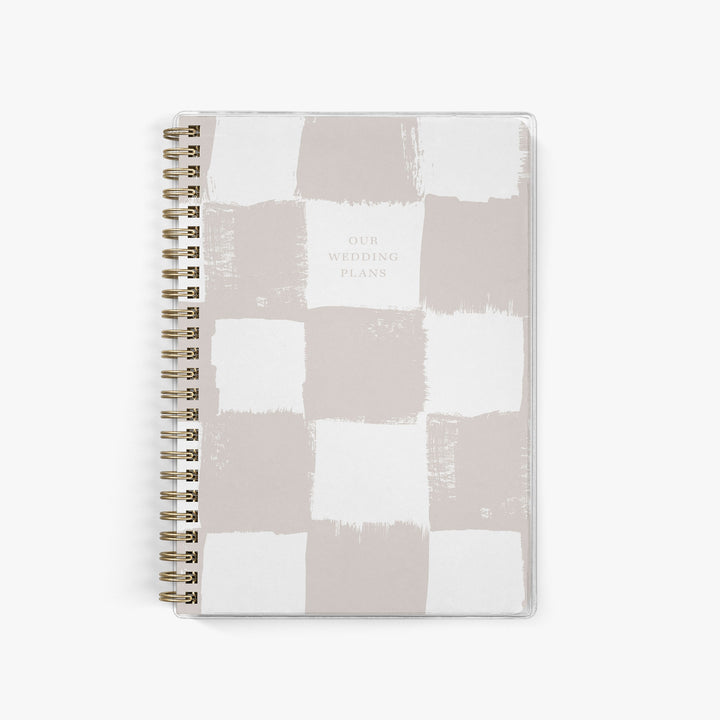 Neutral taupe elopement planner with hand-painted checkerboard cover design, for modern minimalist wedding organization