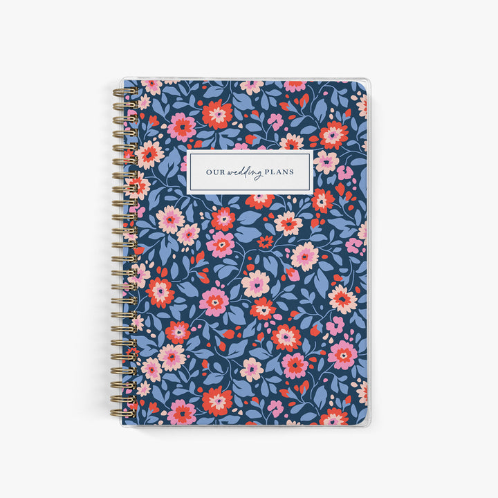 Navy blue elopement planner with colorful, preppy floral pattern, perfect for cheerful and classic wedding planning