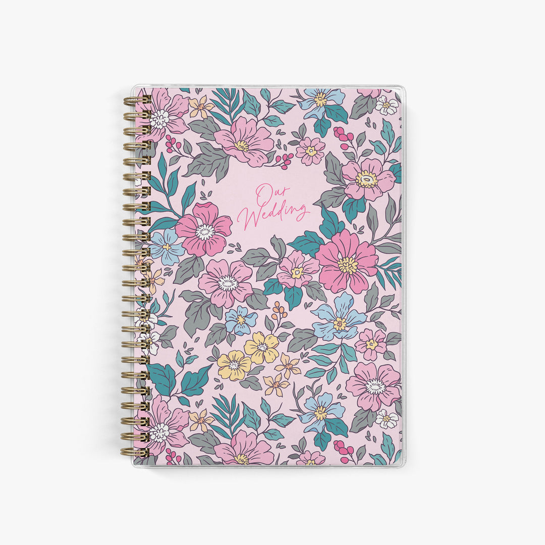 Pink wedding planner with vintage-inspired Liberty floral cover featuring small scattered flowers for romantic elopements