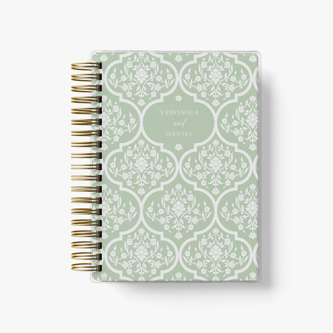 Custom wedding planner featuring a beautiful green and white floral trellis design personalized with the couple's names