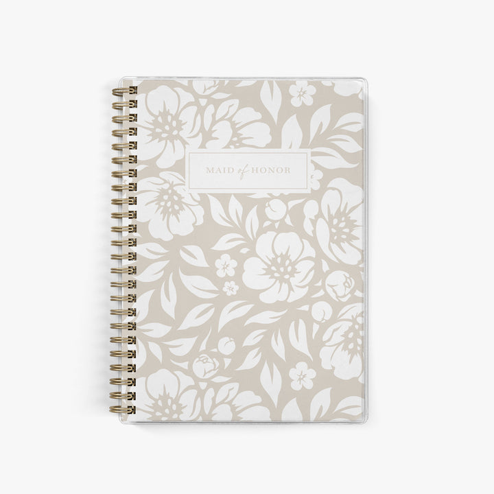 Our exclusive maid of honor planners are the perfect gift for your best friend, shown in a neutral beige floral design.