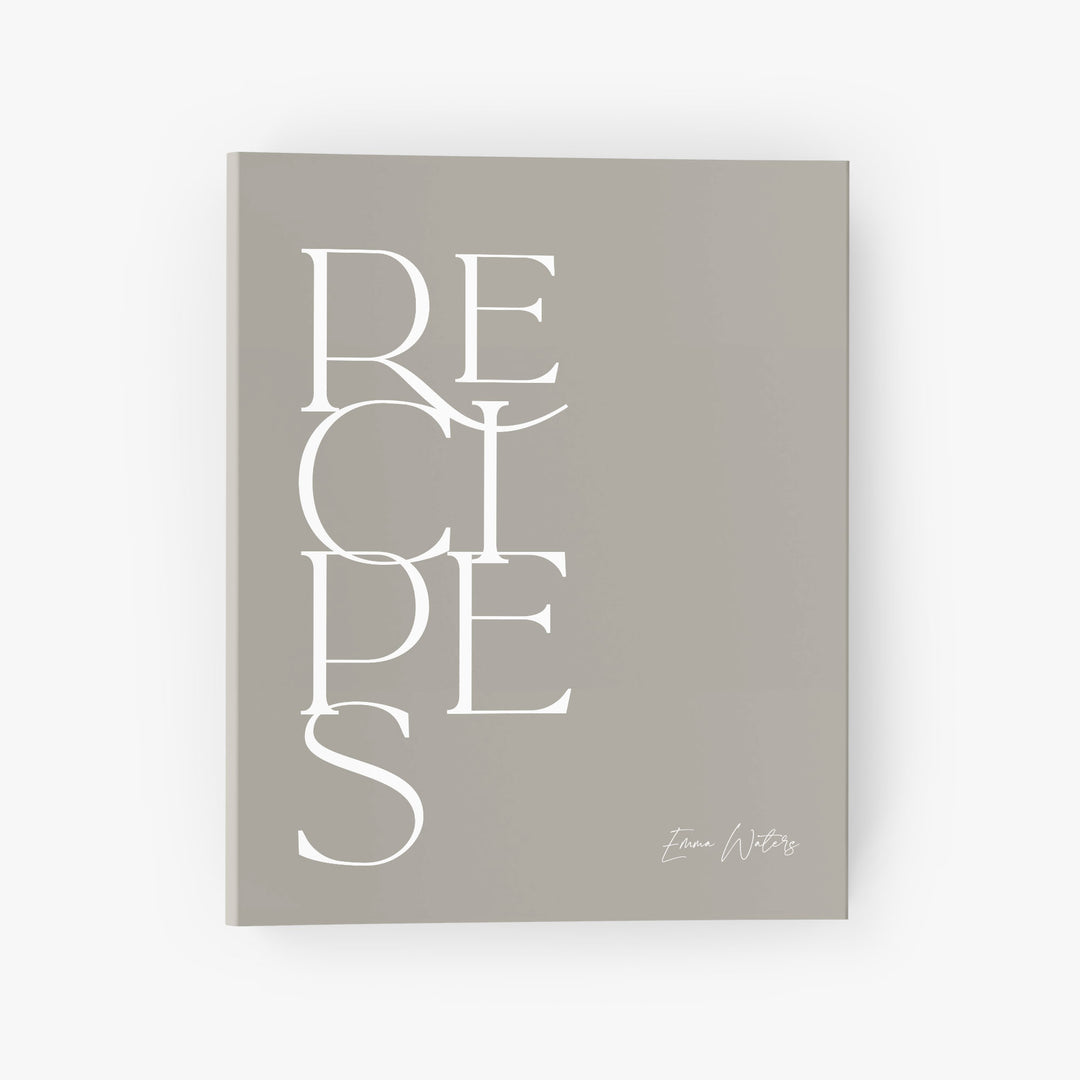 Custom recipe binder in a modern minimalist design featuring bold text in neutral white and beige