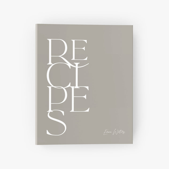 Custom recipe binder in a modern minimalist design featuring bold text in neutral white and beige