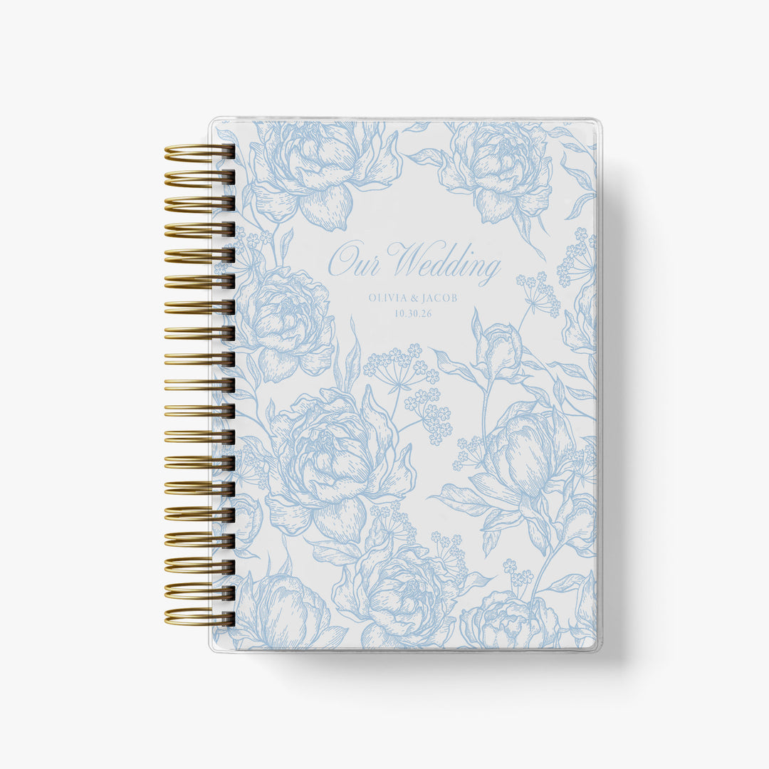 French inspired toile wedding planner featuring lush peonies in classic blue and white with "Our Wedding" on the cover personalized with your names