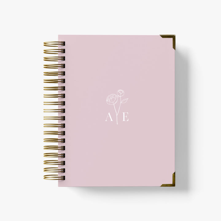 Our luxury wedding planner books are the best a bride can buy, featuring a delicate peony stem with monogram