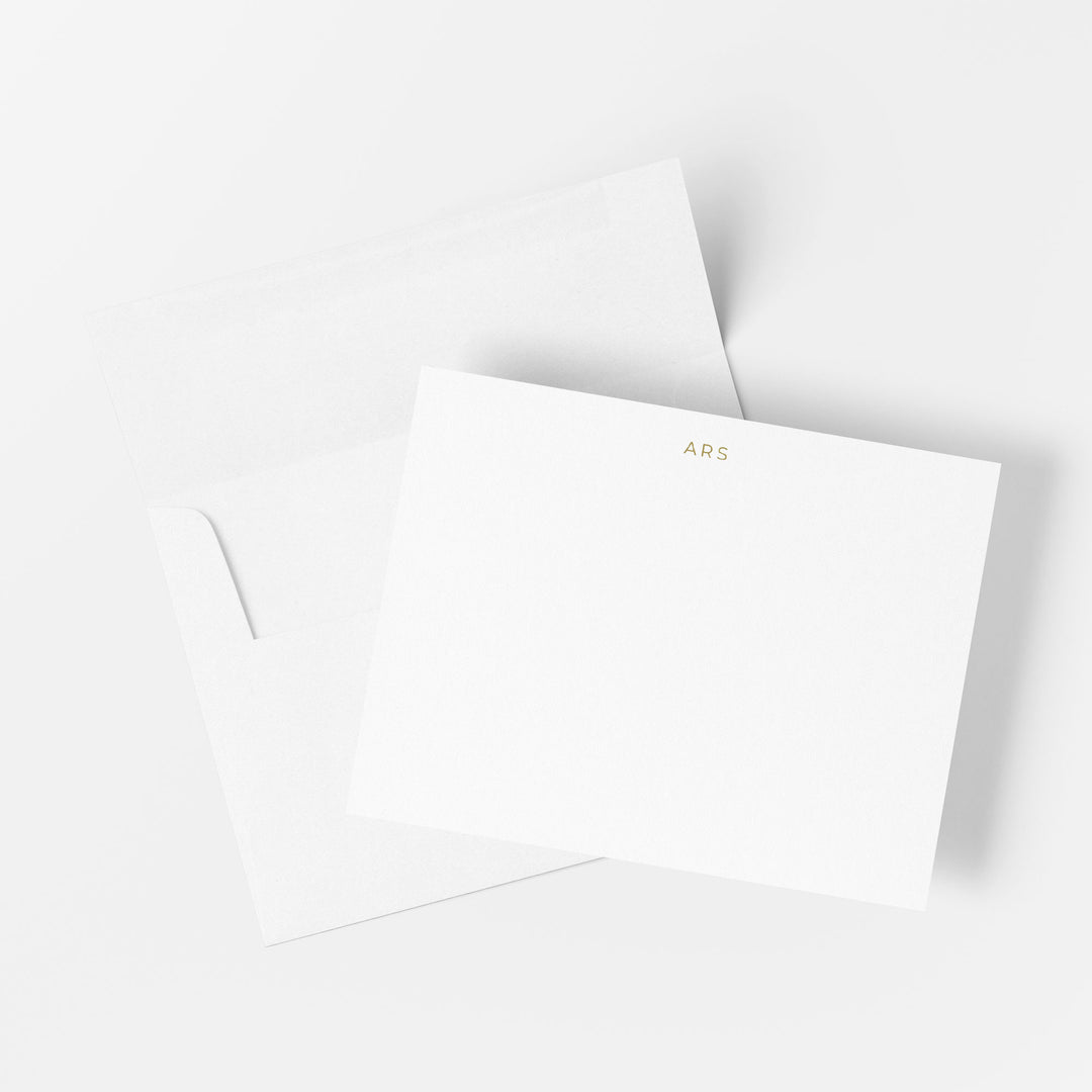 Monogram gold foil note card printed by hand on cotton paper with matching envelope on a white background