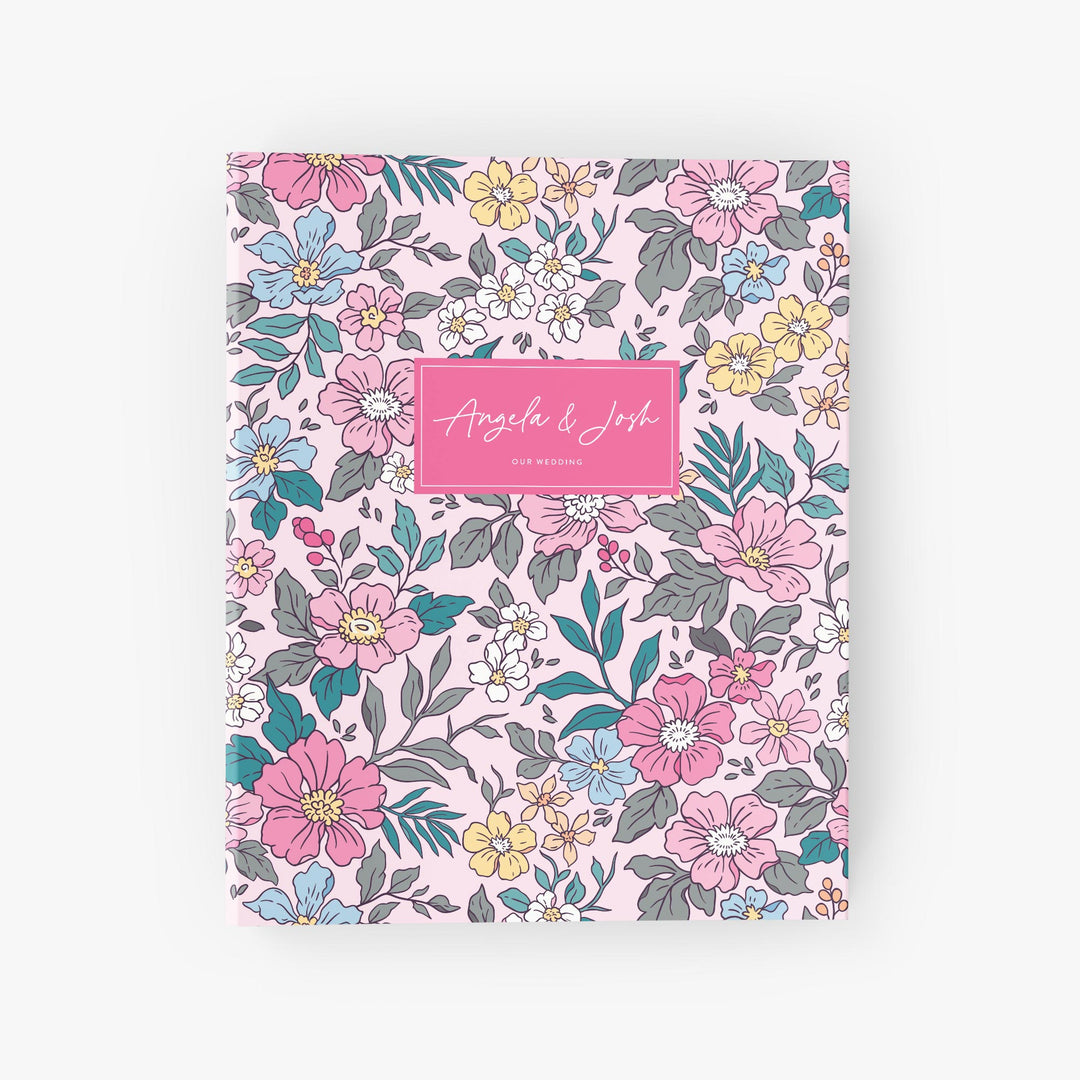 Colorful wildflower wedding binder in shades of pink and green, personalized with the couple's names on the cover